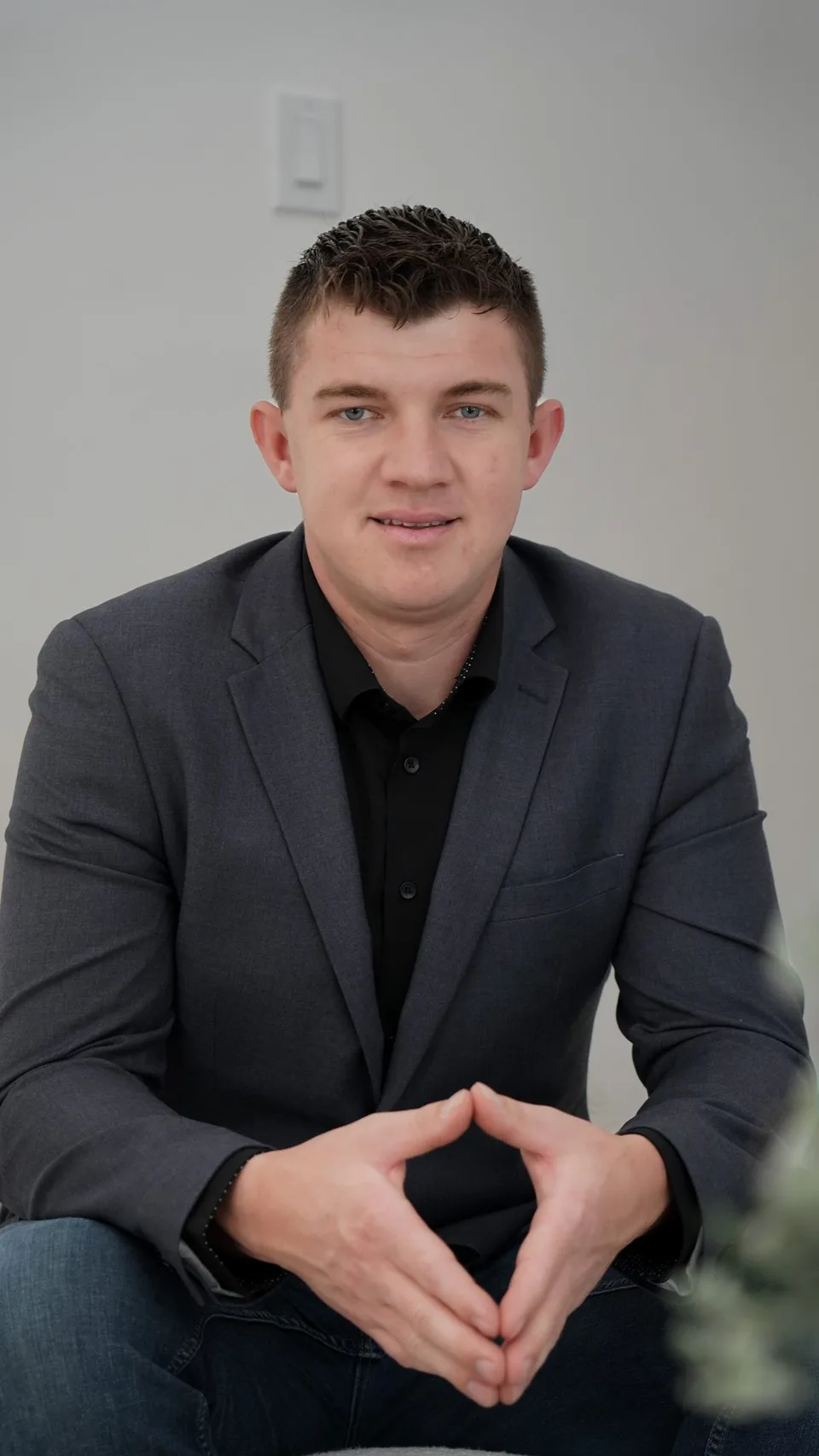 Abe Thiessen, seated, in a grey blazer