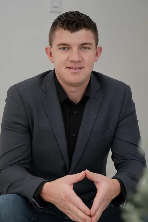 Abe Thiessen, seated, leaning in, hands together